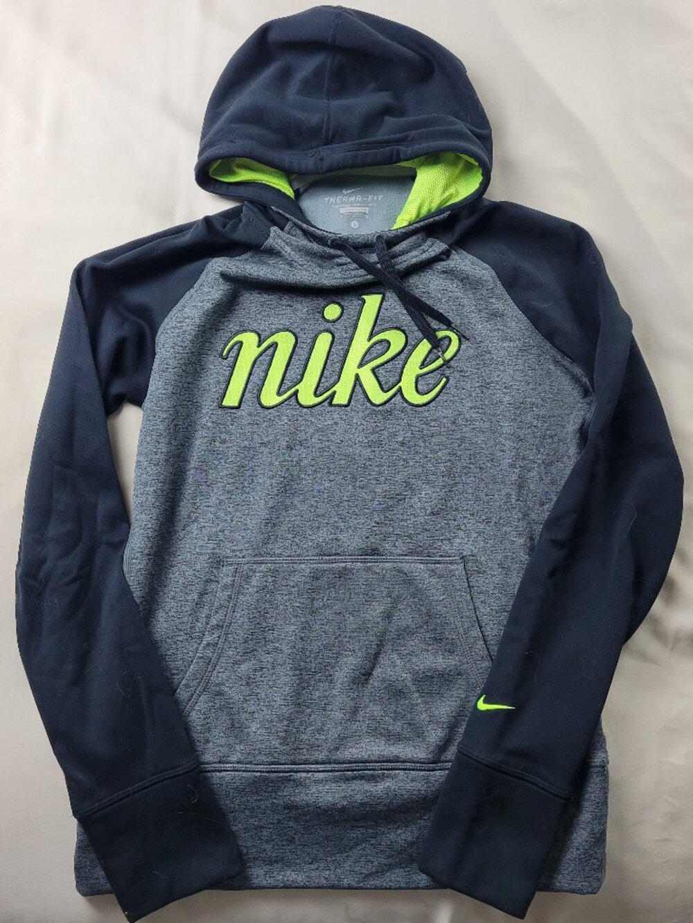Nike Therma-FIT athletic hoodie in gray, black, and lime green